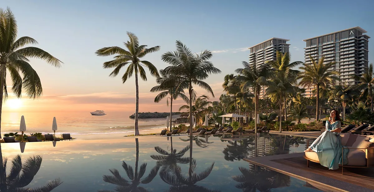 Render of an infinity pool at sunset with palm trees and the residential towers behind
