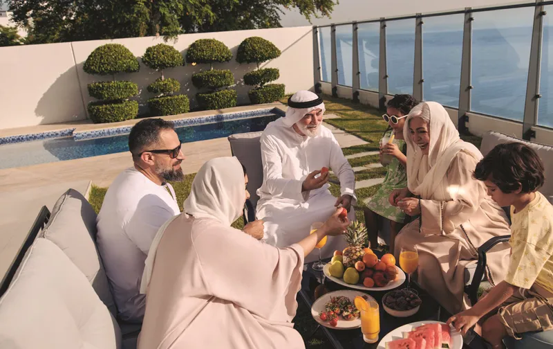 Family gathering on a villa terrace at Al Thuraya Island