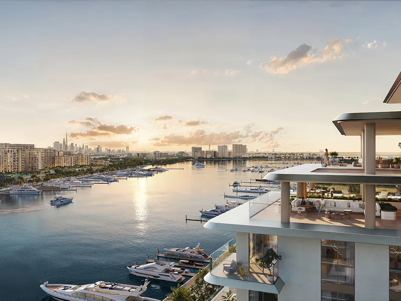 Render of a terrace at Aurea overlooking yacht berths and the Dubai skyline at sunset