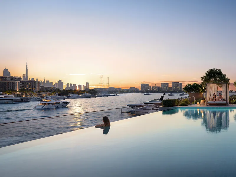 Render of the Aurea infinity-edge pool with a cabana, looking over the marina to the Burj Khalifa