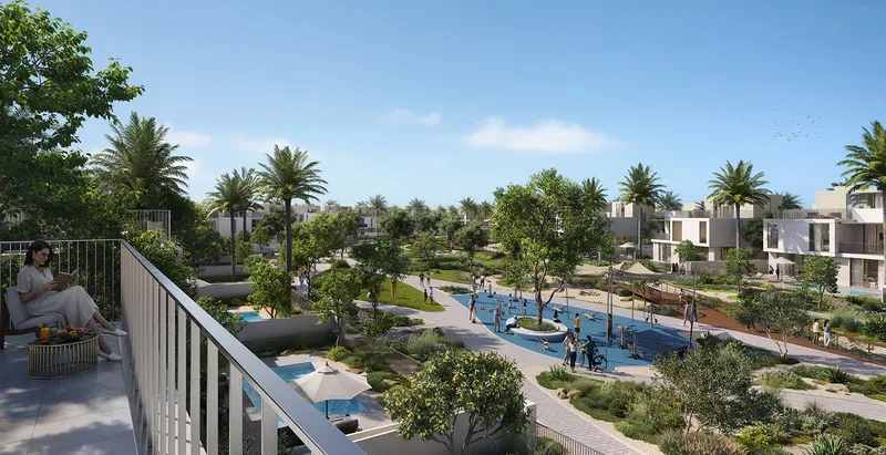 Render of a resident on a villa terrace overlooking landscaped gardens, a splash pad and Avelia villas
