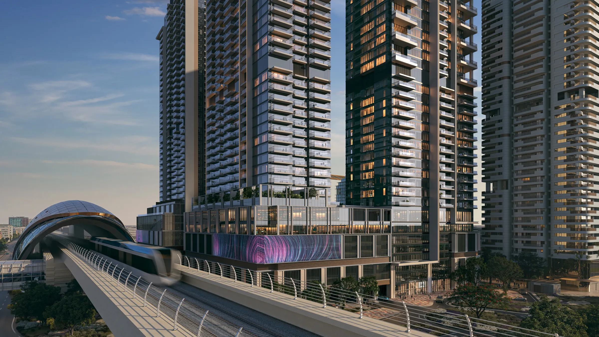 Avenue Park Towers II residential towers at dusk beside the Dubai Metro line in Wasl 1
