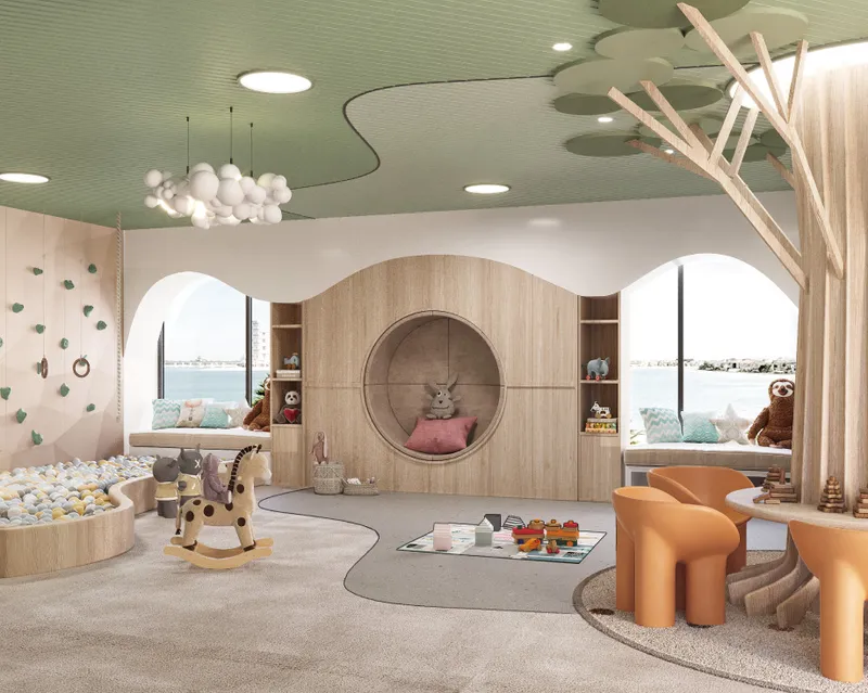 Indoor kids' play area with a reading nook and play structures at Azizi Venice