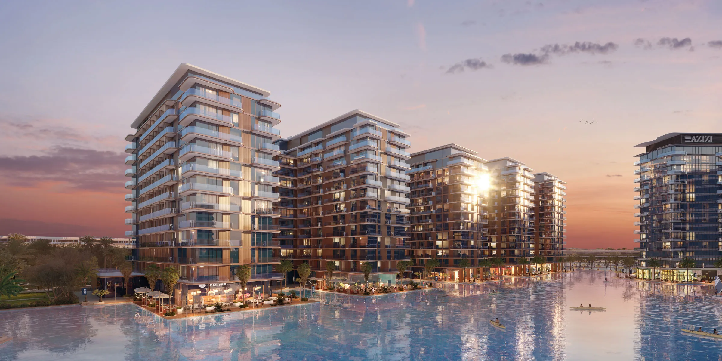 Azizi Venice 6D apartment buildings on the lagoon at dusk