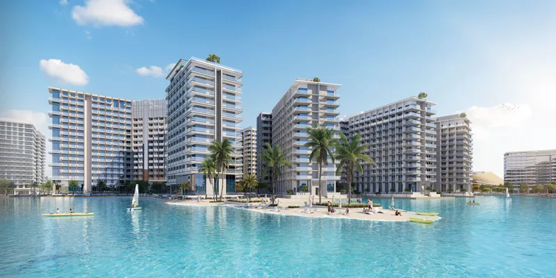 Azizi Venice 6H apartment buildings behind a lagoon beach