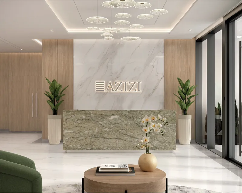 Marble reception desk and pendant lighting in the Azizi Wasel lobby
