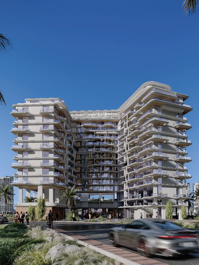 Street view of the Azizi Wasel tower with curved balconies and landscaping