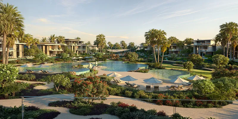 Free-form community pools among palms and villas at Bay Estate