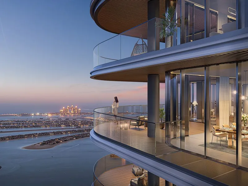 Render of a curved Bayview balcony at dusk overlooking the sea and Palm Jumeirah