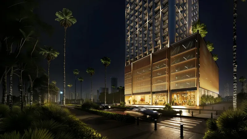 Street-level render of the glazed podium and entrance of Binghatti Etherea at night, lined with palms