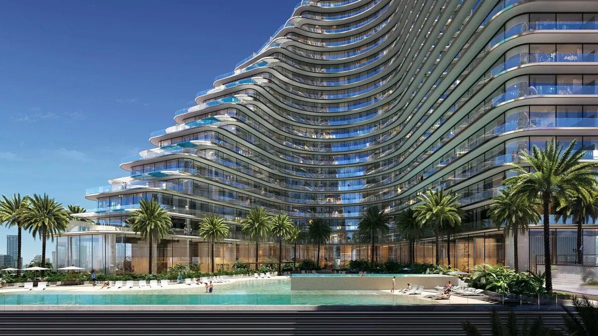 Render of the artificial beach and pool at the foot of a curved Binghatti Flare tower