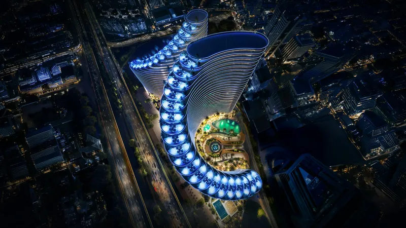Aerial night view of Binghatti Skyflame with its curved, lit terraces and podium