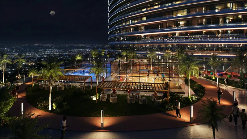 Landscaped podium gardens and walkways at Binghatti Skyflame at night