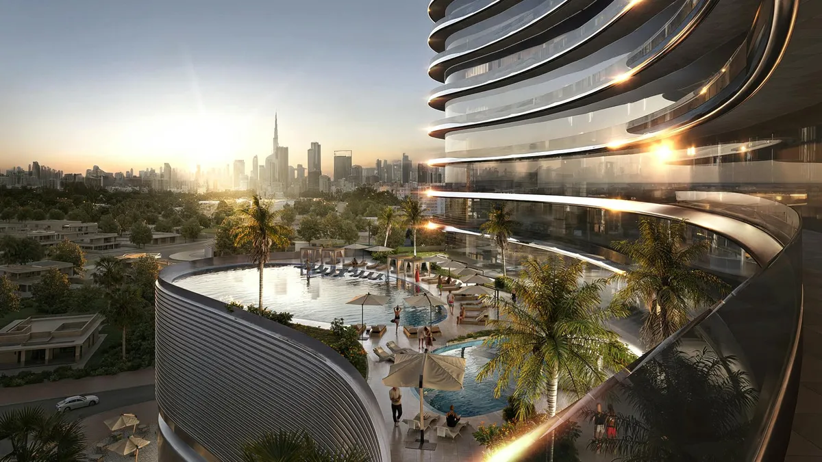 Podium pool deck at Binghatti Skyflame with palms and the Dubai skyline in the distance