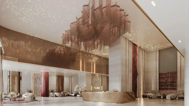 Render of the double-height lobby of Binghatti Skyblade with a sculptural chandelier and reception desk