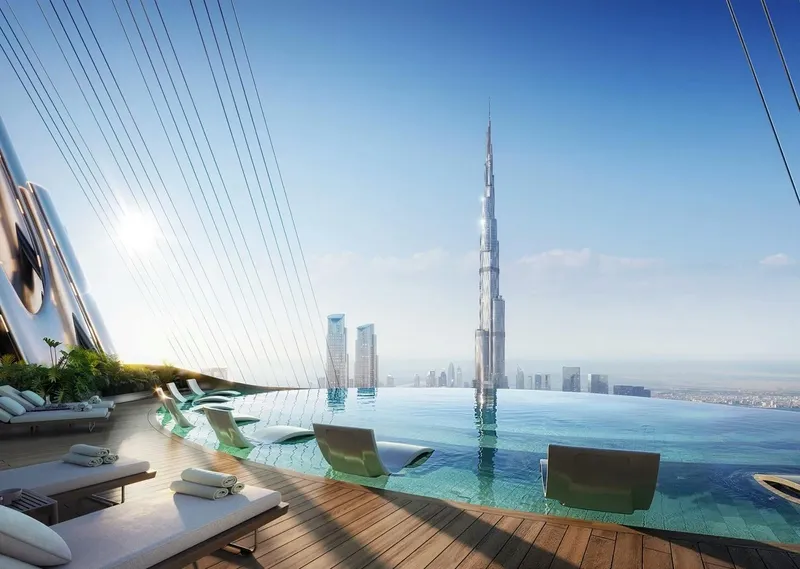 Render of the rooftop infinity pool and loungers at Binghatti Skyblade facing the Burj Khalifa