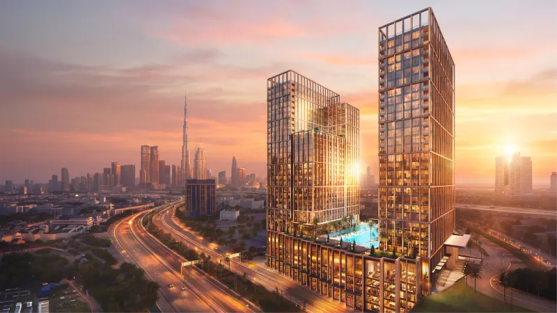 Binghatti Spectre towers on the Al Jaddaf creekside, Dubai, with the crystalline glass facade lit at dusk
