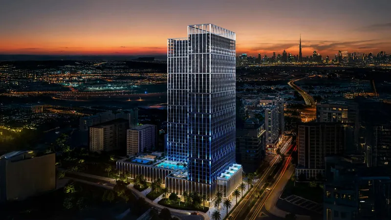 Night render of Binghatti Vintage with its lit facade and podium pool, the city skyline behind