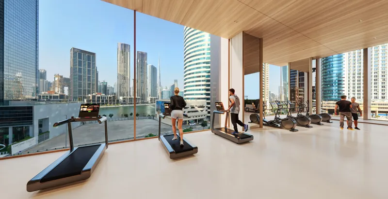 Fitness zone with treadmills facing full-height windows at Burj Capital