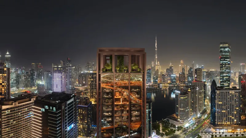 Burj Capital lit at night with the Business Bay Canal and Burj Khalifa behind