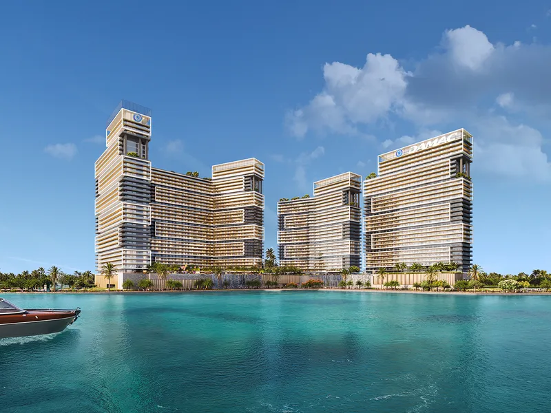 Chelsea Residences towers seen from the sea, with a boat in the foreground