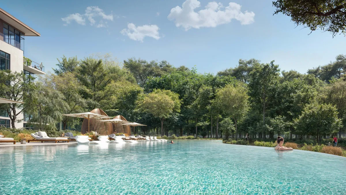 Forest-edge pool with loungers and shaded cabanas at Cilia