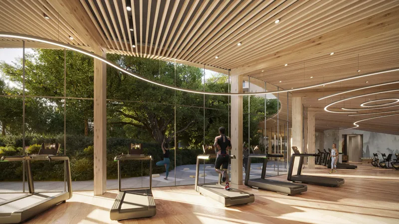 Glass-walled gym with timber ceiling looking onto the forest at Cilia