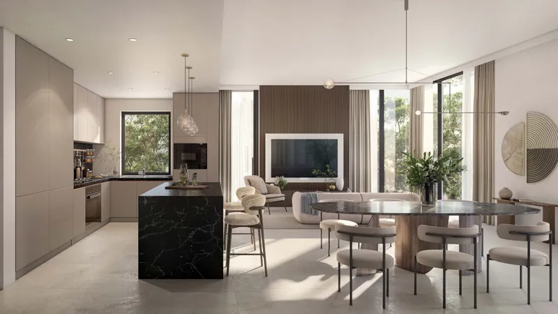 Kitchen with a marble island beside the dining area in a Cilia apartment