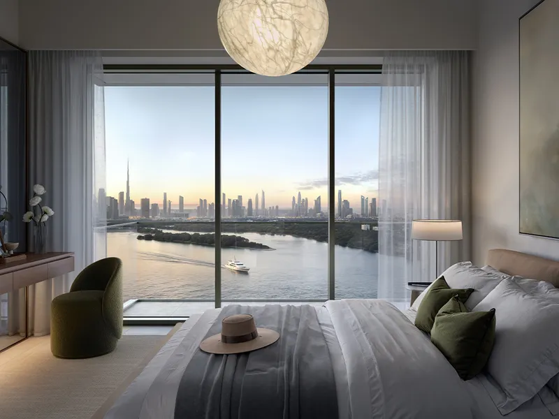 Interior render of a Creek Bay bedroom with a full-height window facing the water and the Burj Khalifa