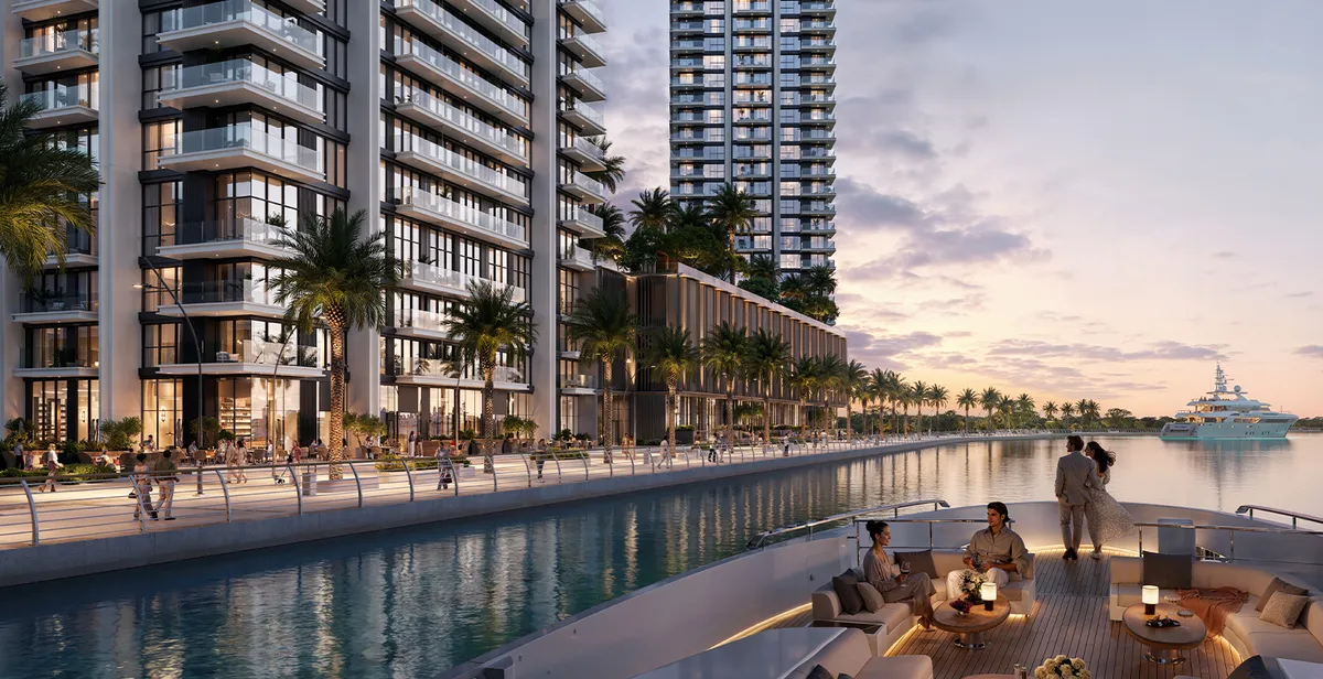 Render of the Creek Bay residences at dusk beside a waterway, seen from the deck of a yacht