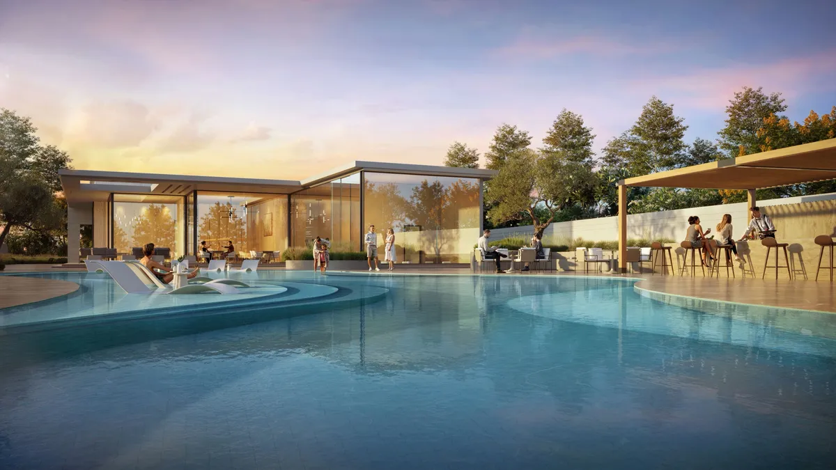Community club pool with a pavilion and loungers at D-Villas