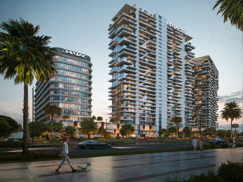 DAMAC District towers seen from a landscaped street with pedestrians