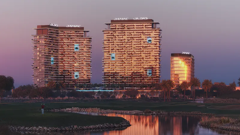DAMAC District towers at dusk, reflected in a lake in DAMAC Hills