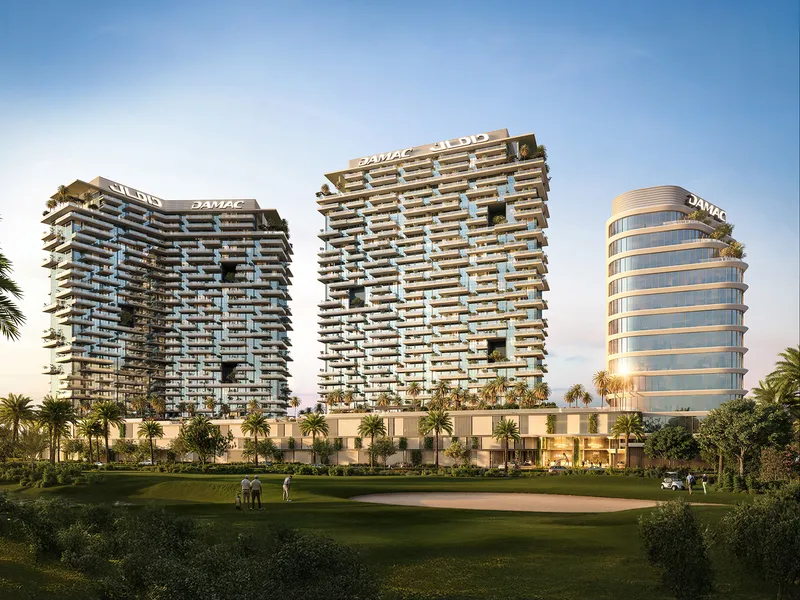 DAMAC District residential towers and curved office building rising behind the Trump International Golf Club greens in DAMAC Hills
