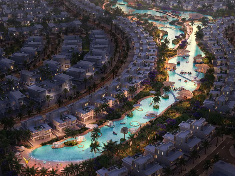 Rows of DAMAC Islands 2 townhouses lining a waterway at dusk