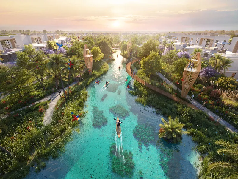 Paddleboarders on a planted water channel running between homes at DAMAC Islands 2