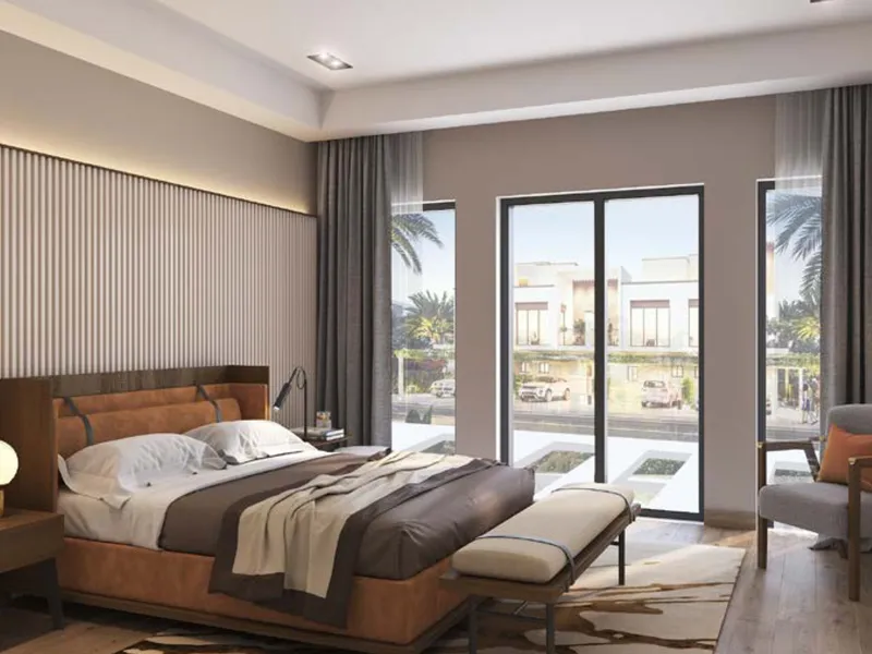 Bedroom in a 5 bedroom DAMAC Riverside townhouse with sliding doors to a balcony