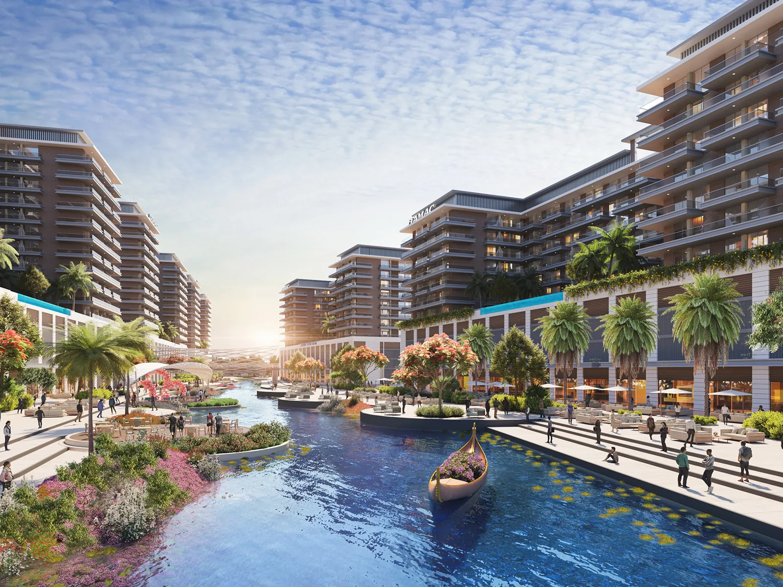 DAMAC Riverside Views apartment buildings lining a river with a landscaped promenade and a small boat