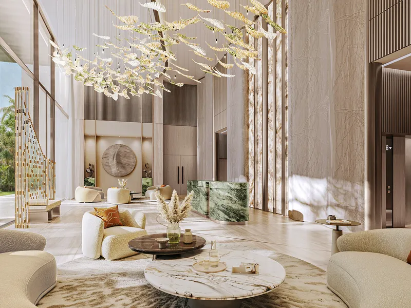 Double-height lobby at Safa Gate with a suspended light sculpture, marble reception desk and lounge seating