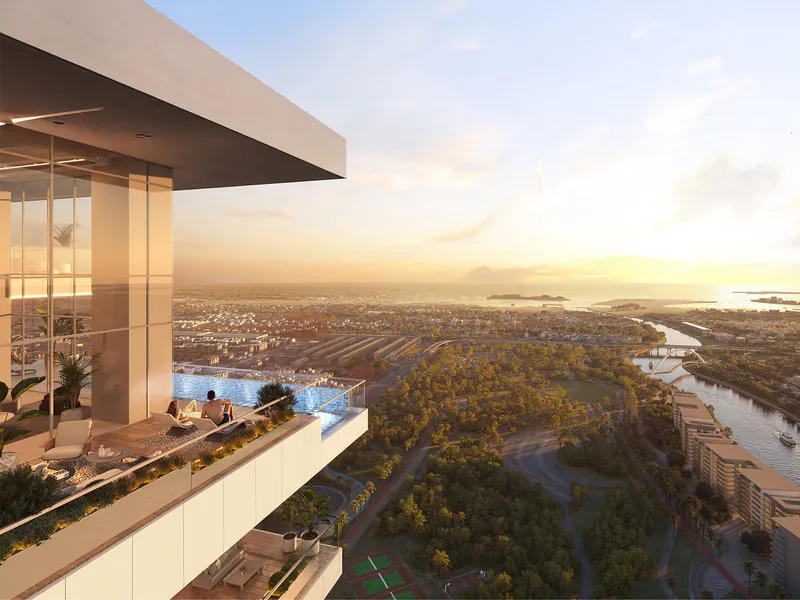 Residents on a high terrace with a pool at Safa Gate, looking over Safa Park and the Dubai Canal at sunset