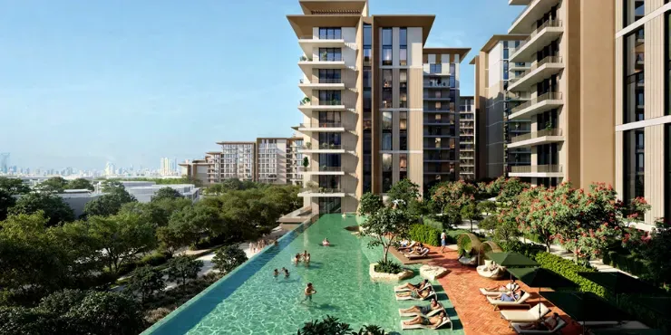 Lap pool running between two Expo Valley Views apartment blocks with the Dubai skyline beyond