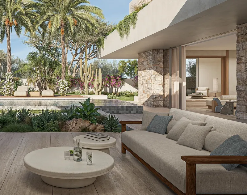Covered terrace of an Aurora villa at Eden Hills with an outdoor sofa looking over the pool and garden