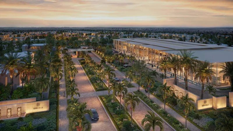 Aerial render of the palm-lined entrance boulevard at Eden Hills with the neighbourhood mall to the right