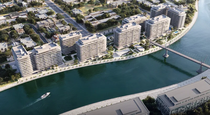 Aerial render of Eden House The Park: seven buildings on the bank of the Dubai Water Canal beside a footbridge