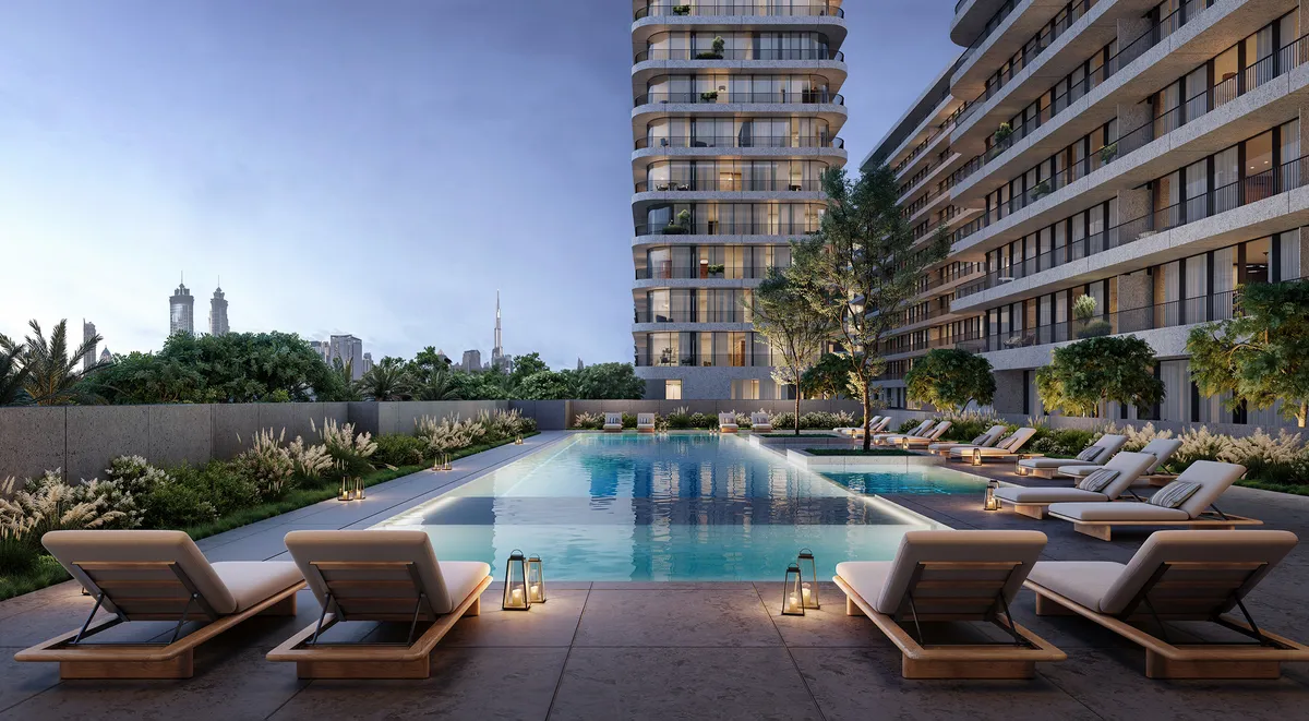 Pool deck with loungers at Eden House The Park at dusk, buildings on either side