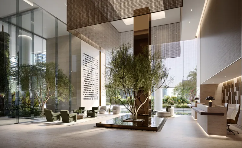 Render of the ENARA lobby with a tree set in a water feature, lounge seating and a reception desk under a high ceiling