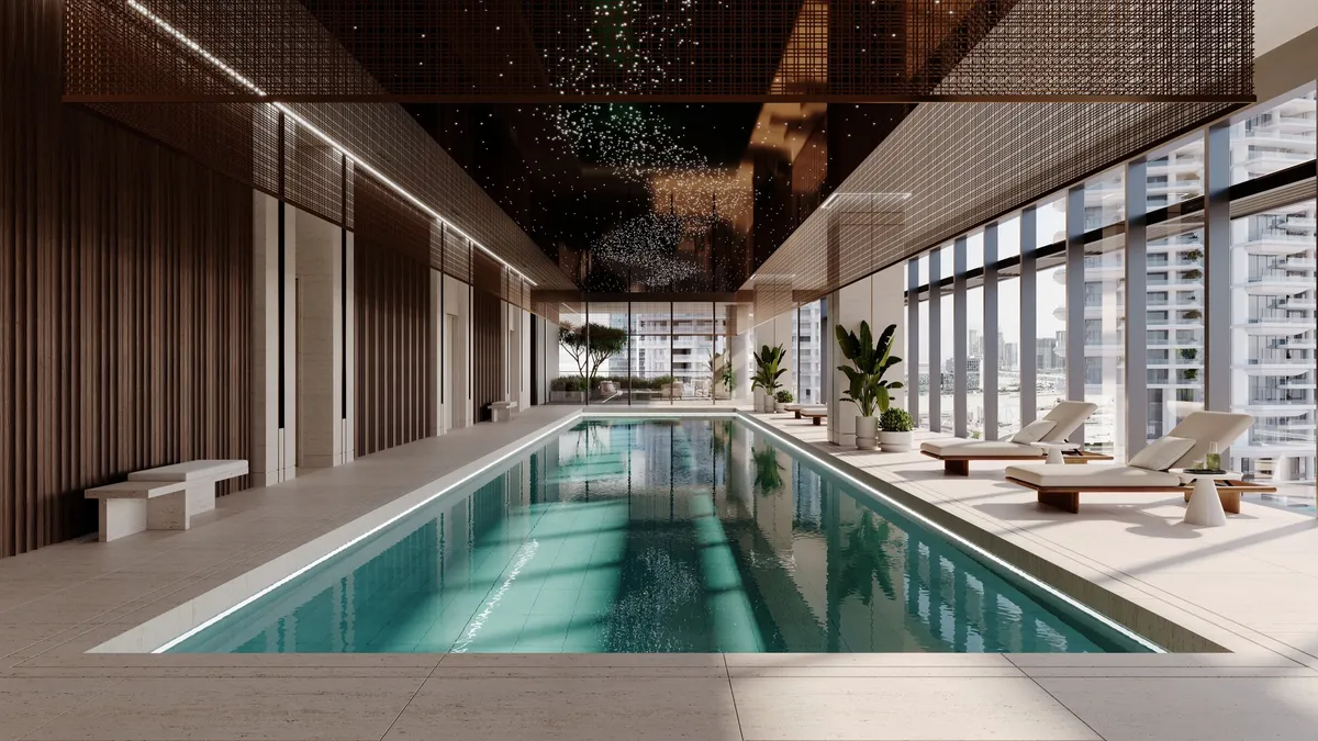 Render of the indoor lap pool in the ENARA spa, lined with loungers beside full-height windows