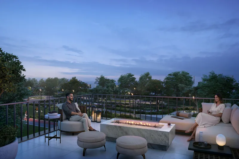 Upper-floor terrace with a fire table overlooking greenery at Equiterra