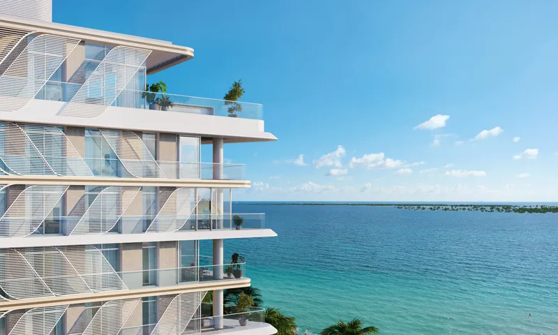 Render of a Fahid Beach Residences building with patterned balcony screens and glass balustrades overlooking the sea