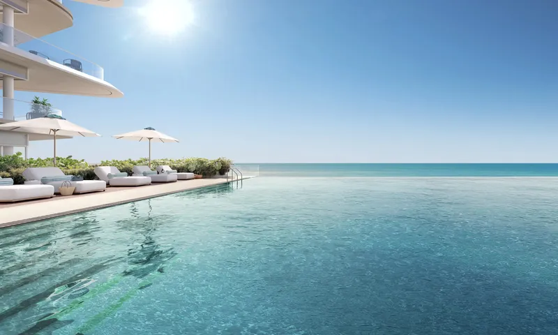 Render of the podium infinity pool at Fahid Beach Residences with loungers and parasols, the sea beyond